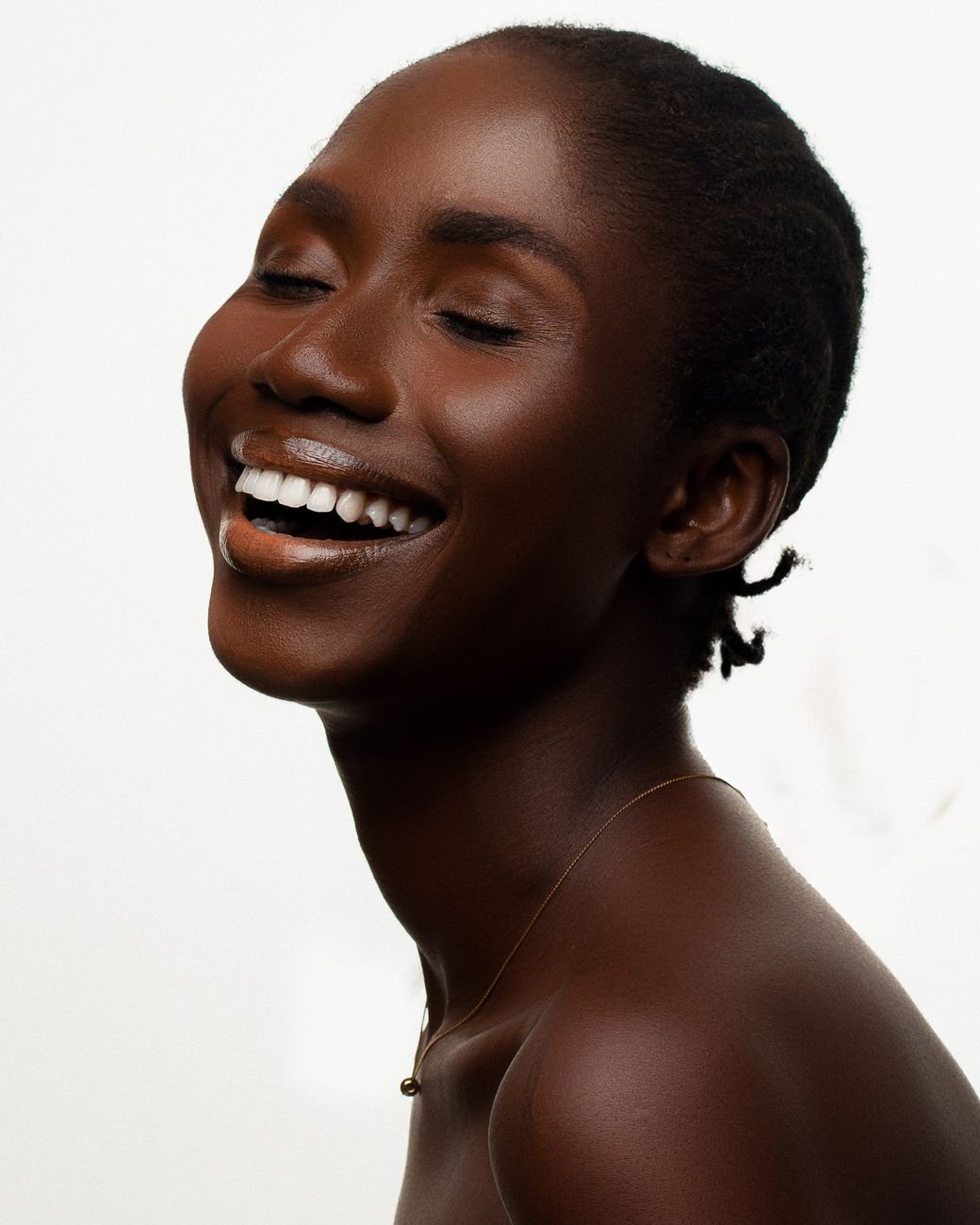 Elegant portrait of a smiling woman with radiant, healthy skin
